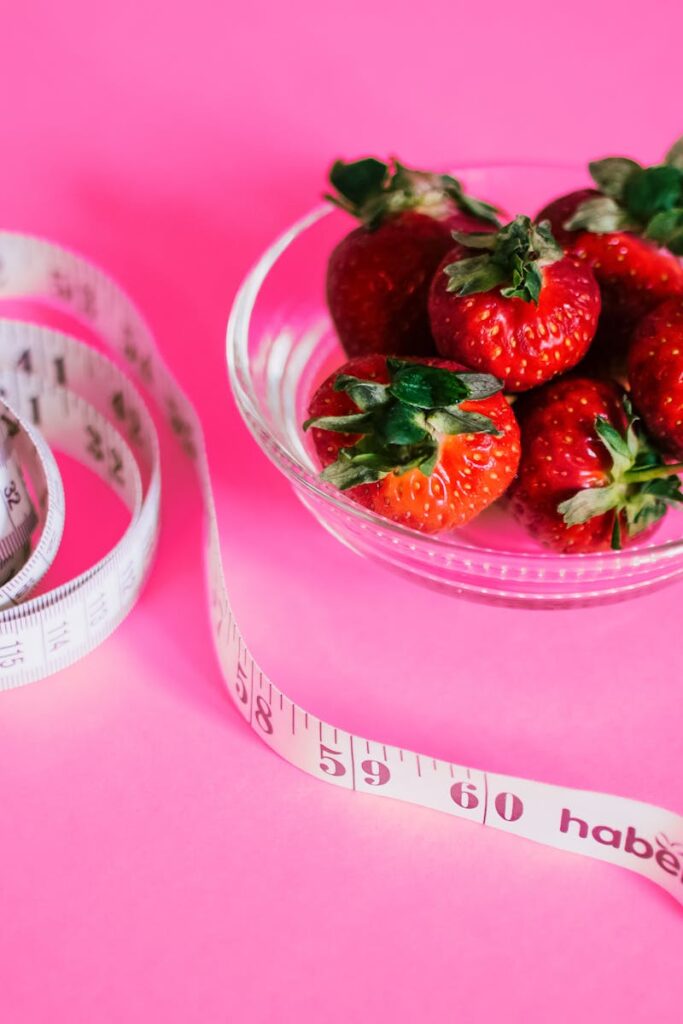 exhilarating fitness cardio regime hustkle fitness belfast jping now gym near me belfast hysrox sgpt A glass bowl of fresh strawberries paired with a pink measuring tape symbolizes healthy eating.