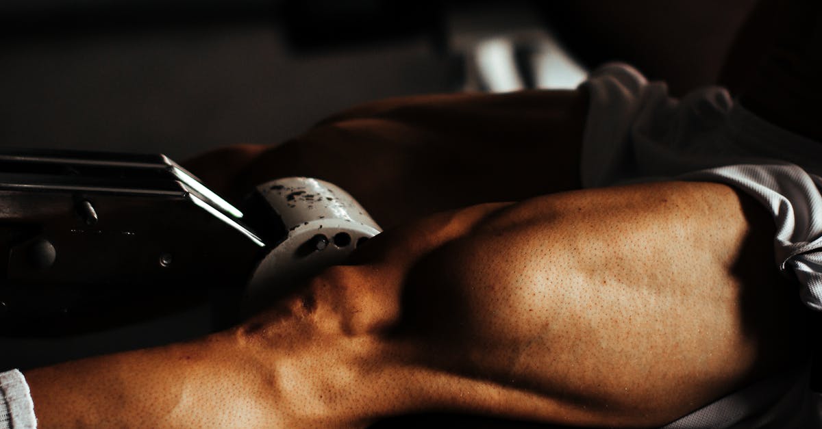 Focused view of a man's muscular legs during a gym workout in București.