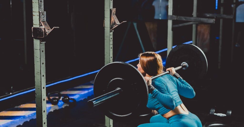 Woman squatting with a barbell in a gym, showcasing strength and fitness focus.